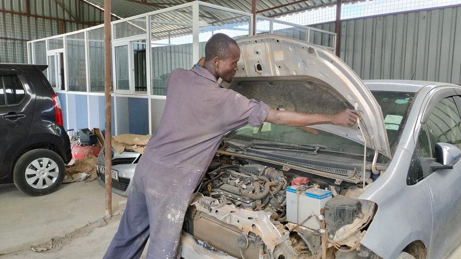 Mechanic working on a car engine