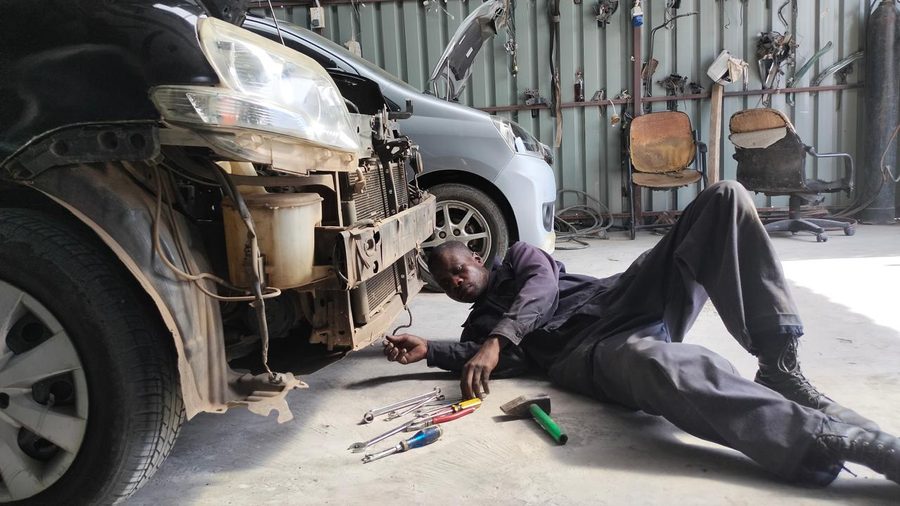 Mechanic working underneath a vehicle