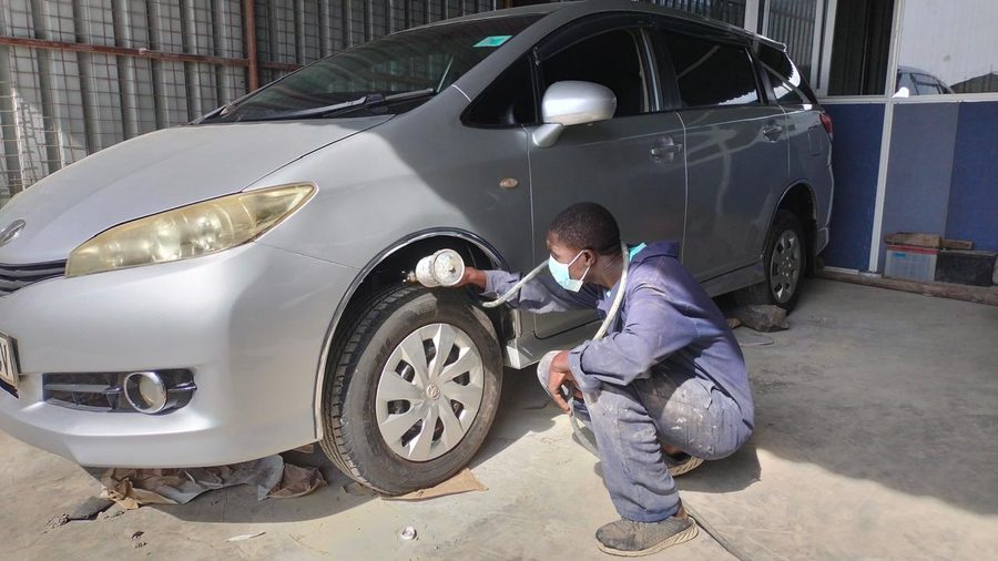 Mechanic checking a car wheel and tyre